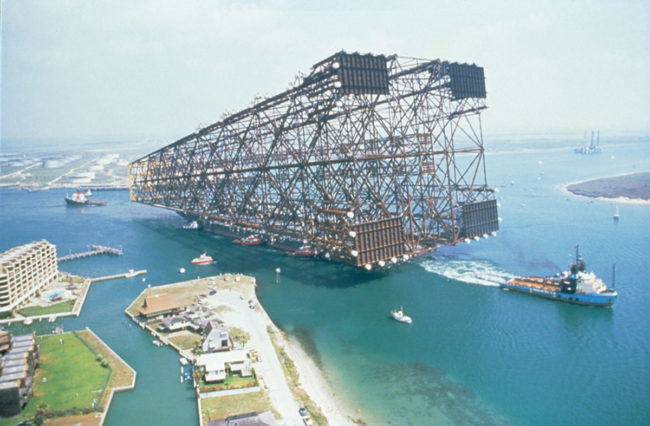 Oil platform being towed out to sea.