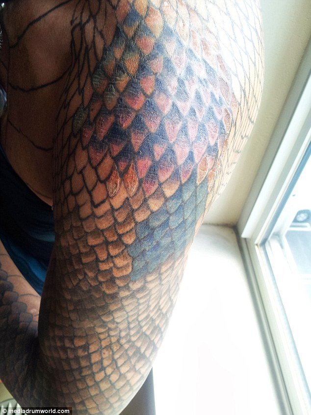 Human reptile: Tiamat shows off her snake tattoo on her arm, part of her dramatic'dragon'  transformation