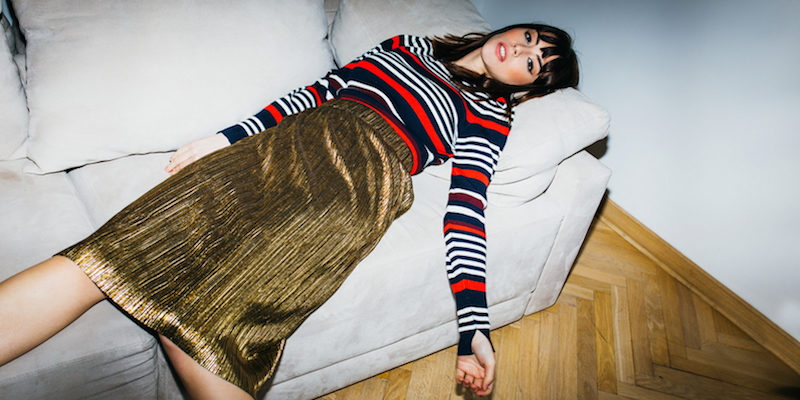 Girl in striped shirt passes out on couch with long skirt on