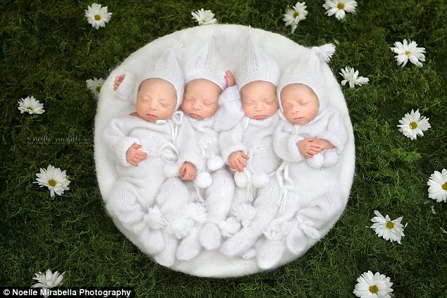 Unusual: The sisters' parents beat odds of one in 15 million to have identical quadruplets naturally