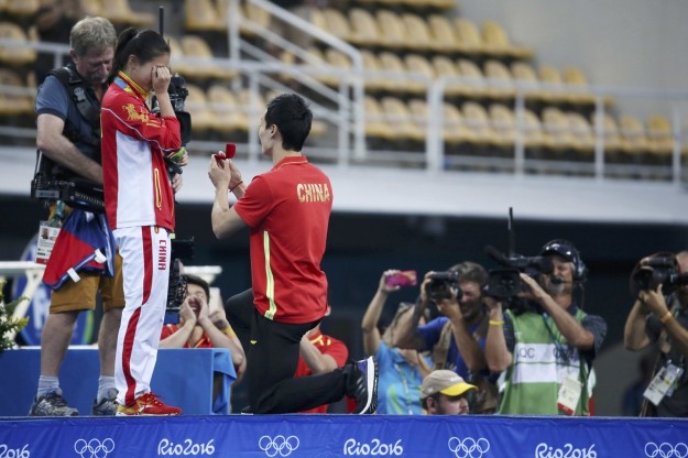 He's boyfriend, fellow Chinese diver Qin Kai, came up on stage and got down on one knee.
