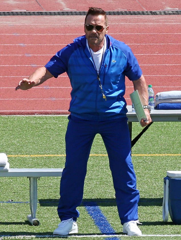 Giving it his all: The former Mr.Universe was in character as he yelled orders across the pitch 