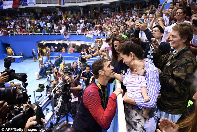 Making babies: Phelps, 31, said he will now focus on 'building a family' with his fiance Nicole Johnson (above last week in Rio with son Boomer)