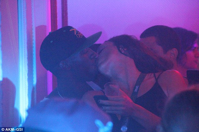 Woman number two: Bolt was pictured photographing another brunette at the club before going home with Duarte