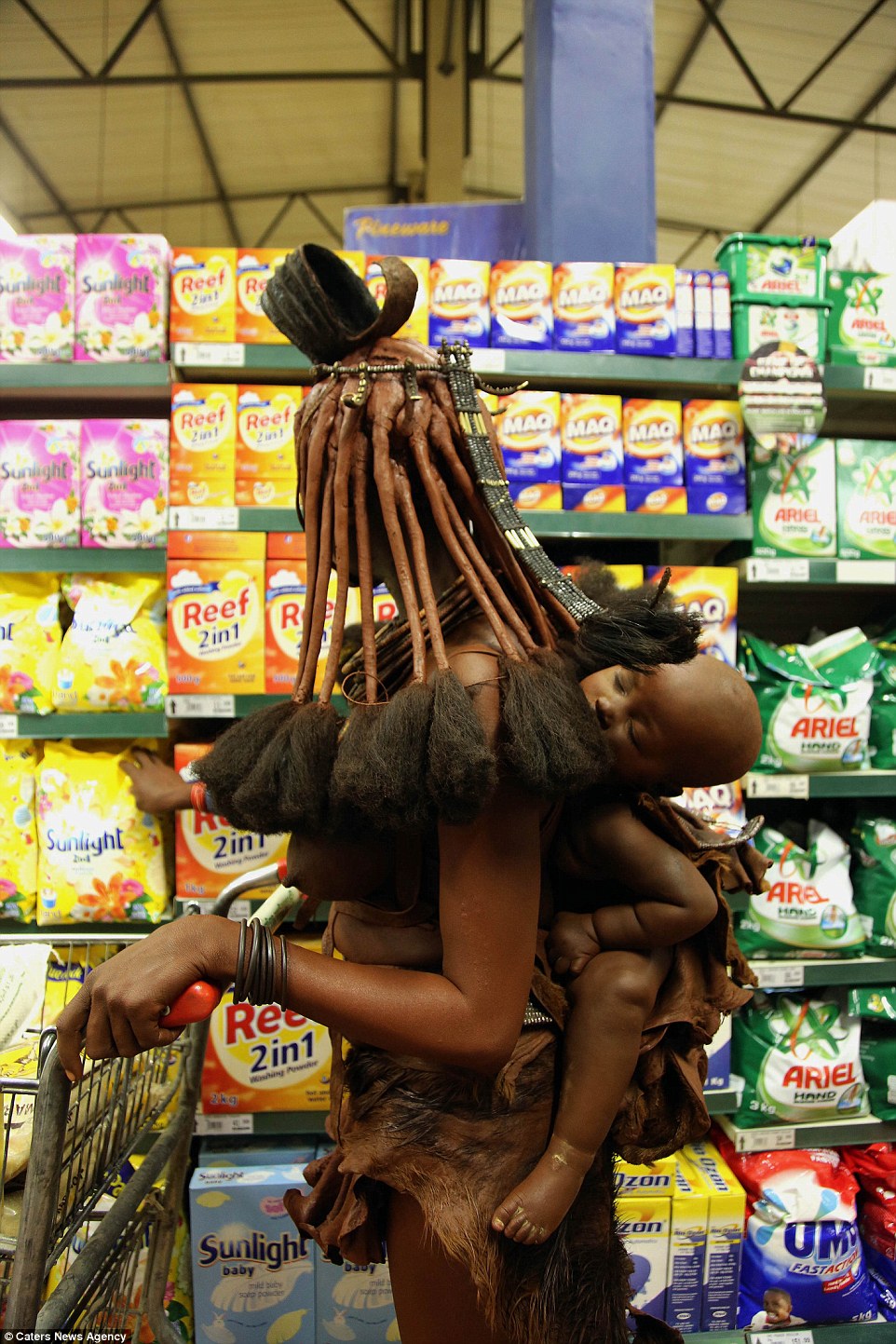 The woman carried a young child as she browsed the shelves of the supermarket in Opuwo, Namibia
