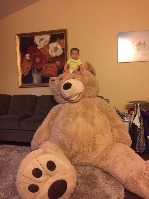 If you don't know or realize just how big this bear is, here are some photos Gonzalez took of her daughter with it in their living room for scale.