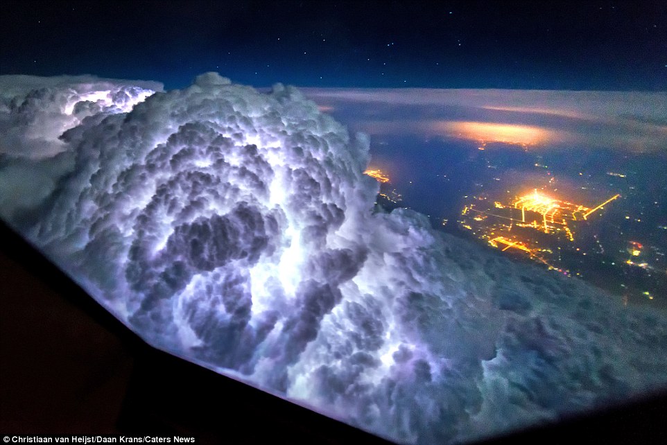 These astonishing pictures taken from an airplane cockpit reveal what pilots see from above. This image shows a cloud illuminated with lightning between Beijing and Shanghai. Van Heijst said: 'The cloud here seen on our left started to appear on our weather radar only a few minutes before and started to show off an amazing display of lightning that grew ever more intense. When we got closer, we saw that the cloud was going to burst through our flight path and we had to deviate up to 10km to avoid flying into this cell'