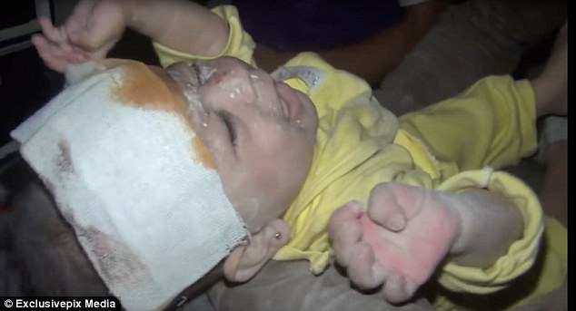 Inhumane: The tiny baby girl wailed after she suffered cuts and bruises to her face but survived being crushed under rubble
