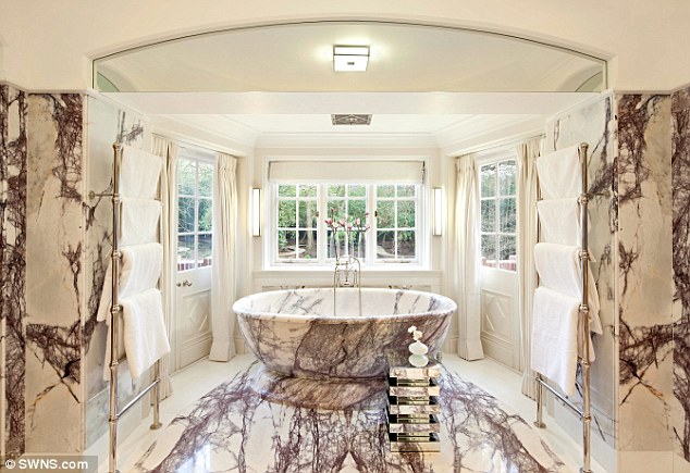 The bathroom, pictured, in the 24,000 sq ft house is made from 12 types of Italian marble 