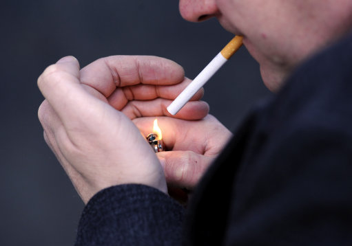 Embargoed to 0001 Monday October 3 PICTURE POSED BY MODEL File photo dated 12/03/13 of a man lighting a cigarette. Smoking materials are still the biggest cause of accidental fire deaths, the Northern Ireland Fire and Rescue Service has warned.