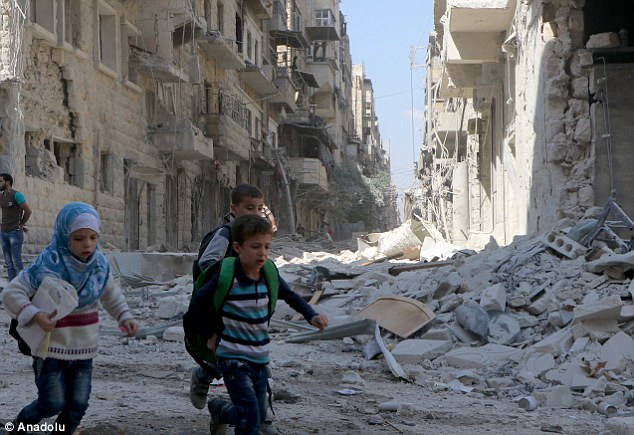 Escape: Syrian children flee from a bombsite after the Russian army attacked the opposition controlled Firdevs neighborhood in Aleppo, Syria last month. Trump's victory is likely to hasten the recapture of Aleppo by Assad, Michael Burleigh suggests