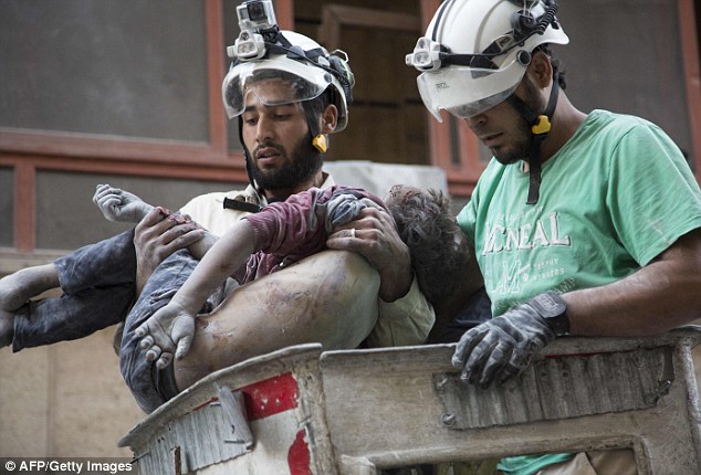 Victims: Heartbroken Syrian rescuers hold the body of a girl after pulling her from rubble of a building following a government forces air strike in the rebel-held neighbourhood of Al-Shaar in Aleppo in September. Trump's triumph is likely to have repercussions for the civilians of Aleppo