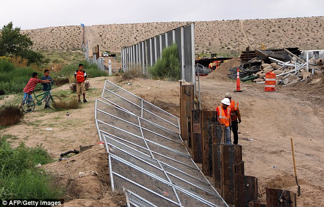US workers replace fencing with a higher new metal wall along the border between Ciudad Juarez and Sunland Park, New Mexico.The obstacles to a 'Trump Wall', which Michael Burleigh believes will not be built, are actually rivers, lakes and Texan landowners 
