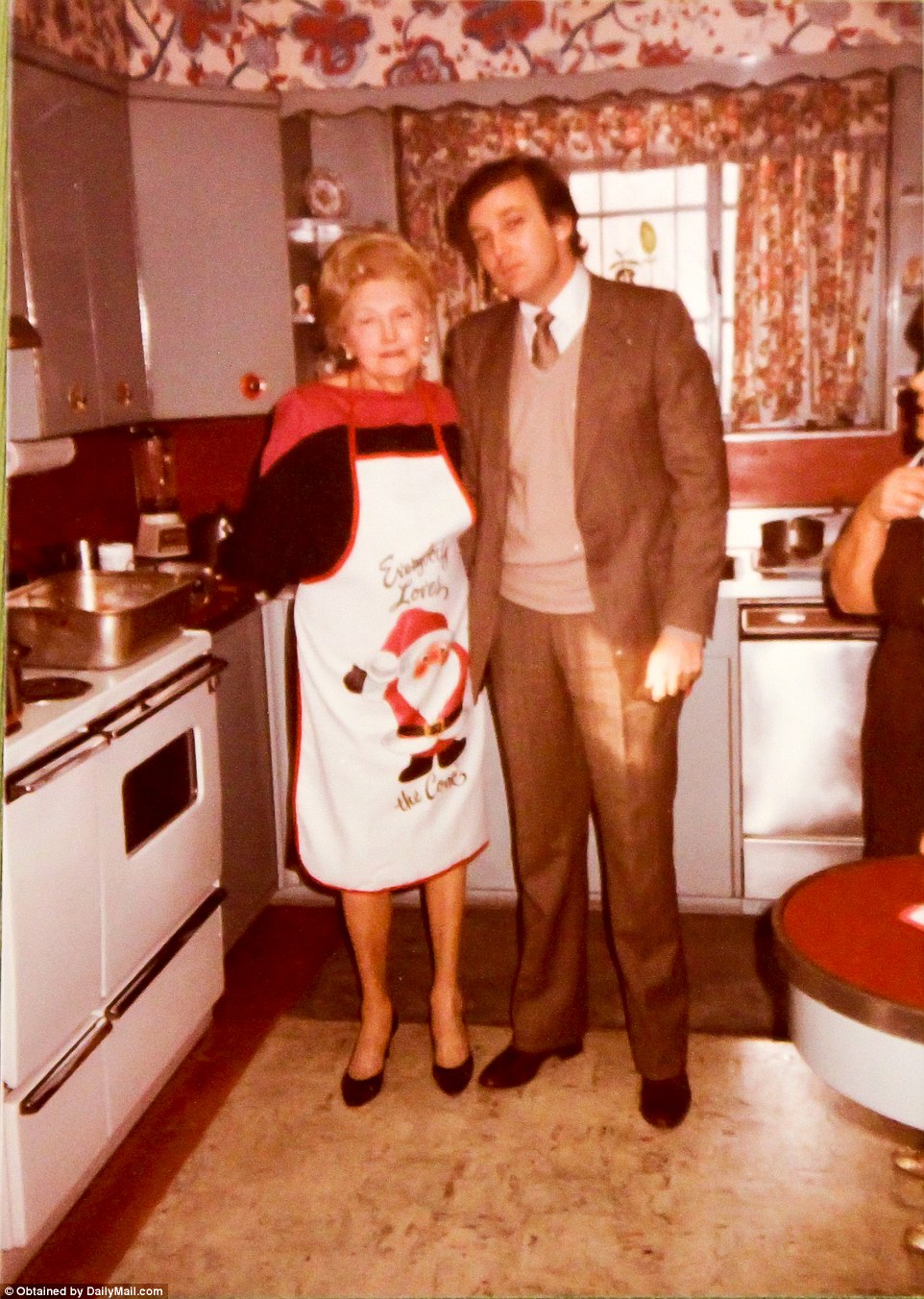 Someone's in the kitchen with mama. It's Donald with his mother Mary Trump hanging at Christmastime. Mary passed away in August 2000
