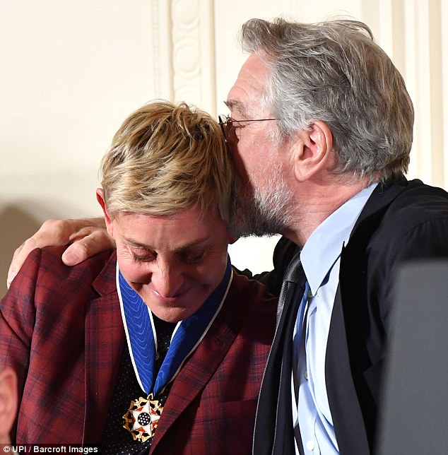 Comforting: The double Oscar winner then planted a sweet kiss on the side of Ellen's head as she leaned in towards him