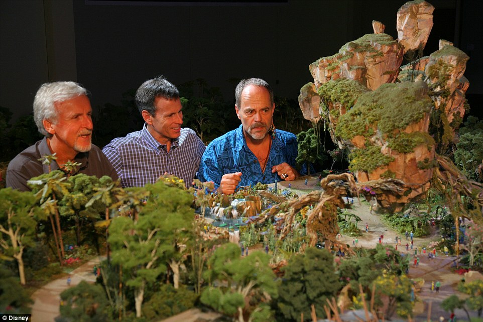 Walt Disney Imagineering's Joe Rohde (right) shares highlights of the project model with Cameron (left) and Walt Disney Parks & Resort Chairman, Tom Staggs