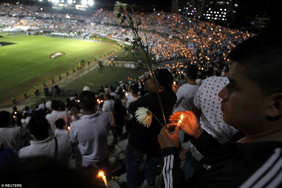 Fans of Atletico Nacional soccer club hold candles as they pay tribute to the players of Brazilian club Chapecoense killed in the recent airplane crash