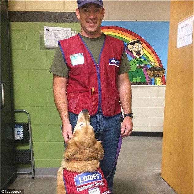 U.S. Air Force veteran Clay Luthy and his service dog golden retriever, Charlotte, both wear red and blue Lowe's vests to work at the home improvement retailer