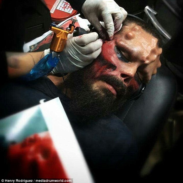 Images show the 37-year-old's journey as he first gets his eyes tattooed black, has implants inserted into his head and then undergoes a painful operation to have part of his nose removed
