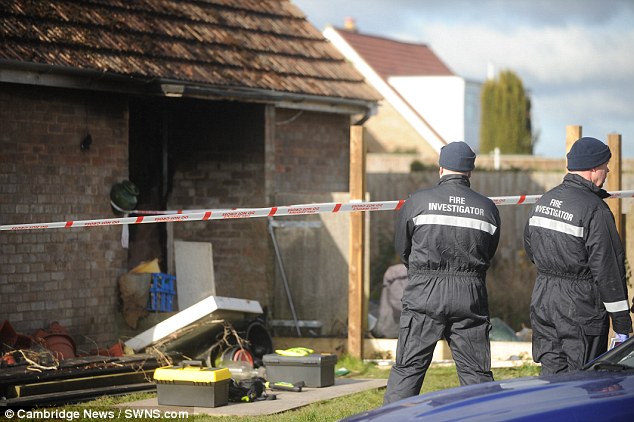 The inquest heard how there was no smoke alarm fitted and firefighters couldn't gain access through a kitchen due to 'goods stored behind the door'. Pictured, investigators at the scene