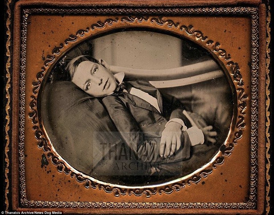 This dead boy's eyes have been propped open as he lies on a 'fainting couch' in an image taken in 1853