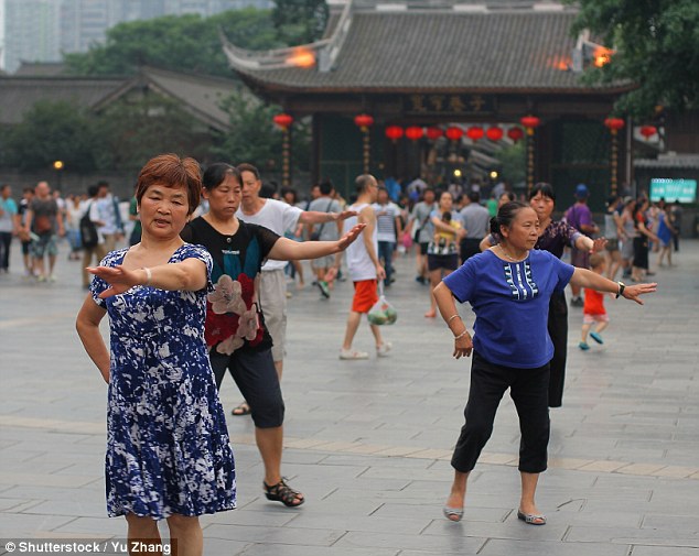 Square dancing: Middle-aged and retired women practise fan dancing and shadow boxing as morning exercise routine often in a square or plaza (file photo)