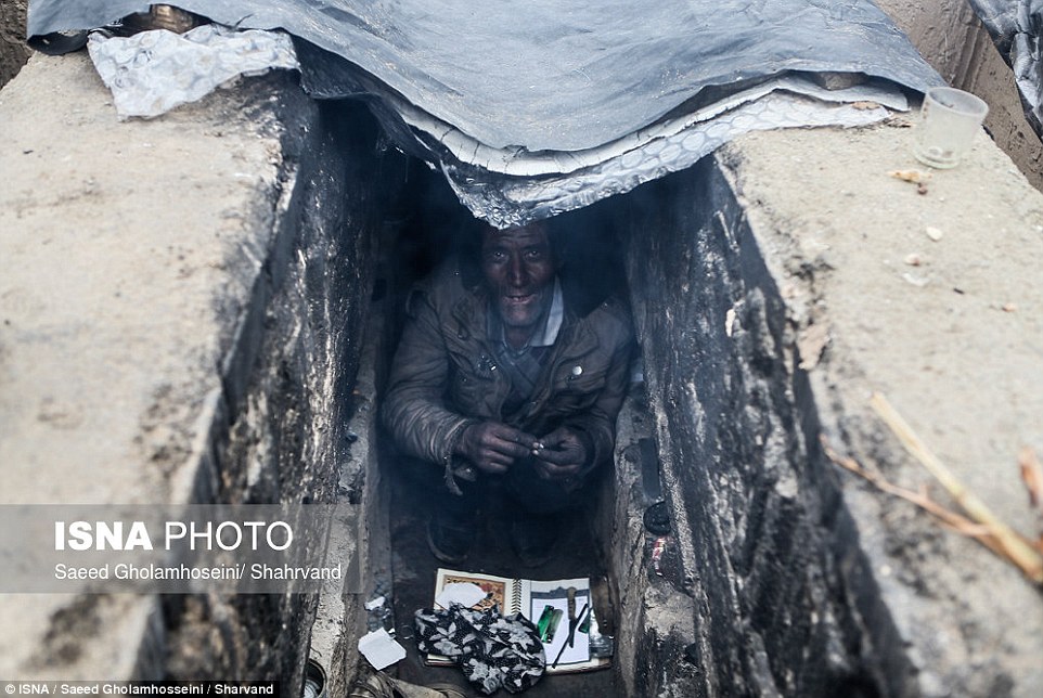 A man living in an empty grave close to Tehran, in images which have caused an outcry in Iran