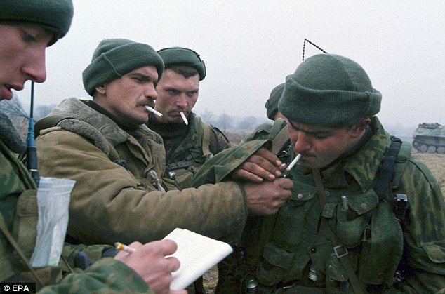Russian soldiers smoking during a break in fighting in Chechnya in 2000. But nowadays the Putin regime emphasises health and fitness and frowns on smoking in the armed forces