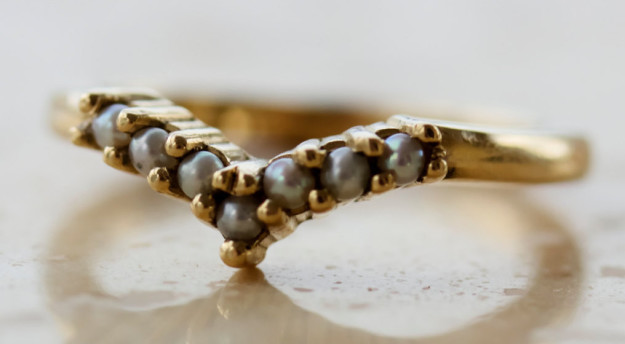 A V-shaped ring that has all its ducks — I mean, pearls — in a row.