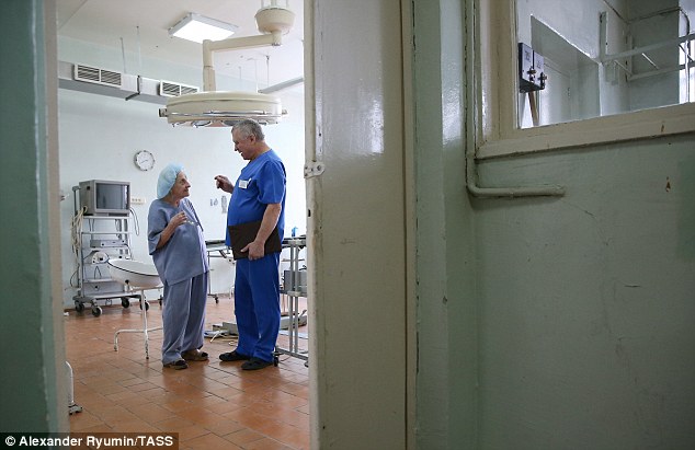 Russia's oldest working surgeon chats to a colleague inside one of the operating rooms