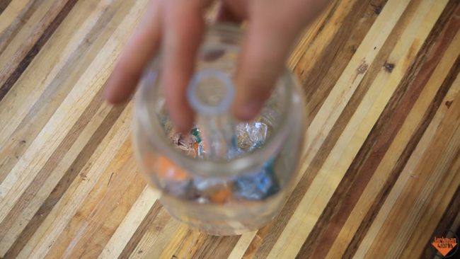 With the tube in place, he began filling the jars with the colorful shards.