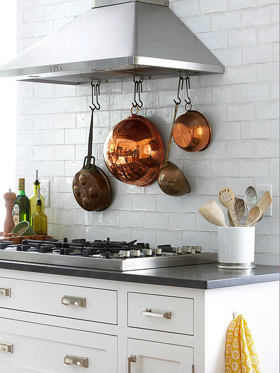 Hang S hooks from a ventilation hood to display pots and pans.