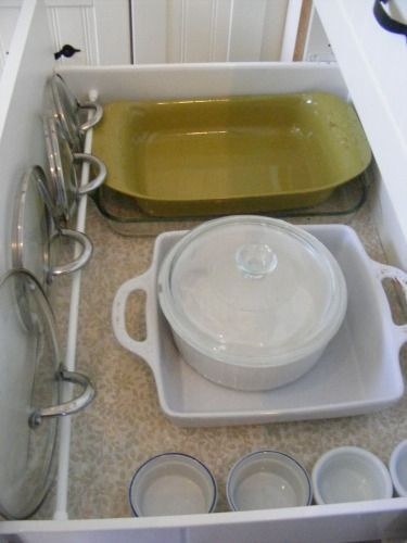 Put a tension rod in a deep kitchen drawer to hold your lids in place.