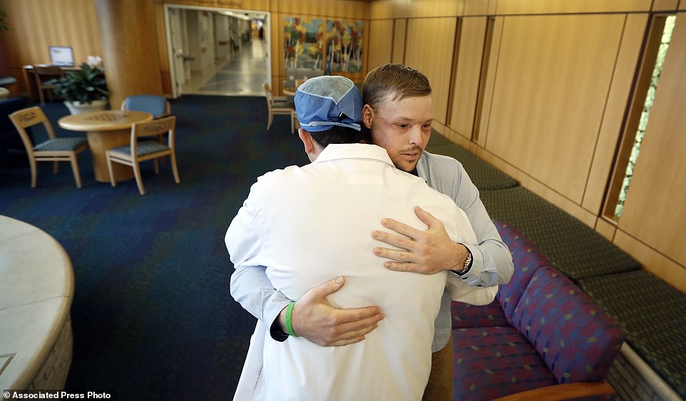 Unbreakable bond: Andy is hugged by Dr. Samir Mardini after another follow up procedure at the Mayo Clinic in Minnesota in January 