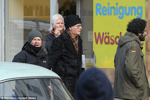 Wrapped up: Wearing black beanie and a matching overcoat, Tilda played the part to perfection