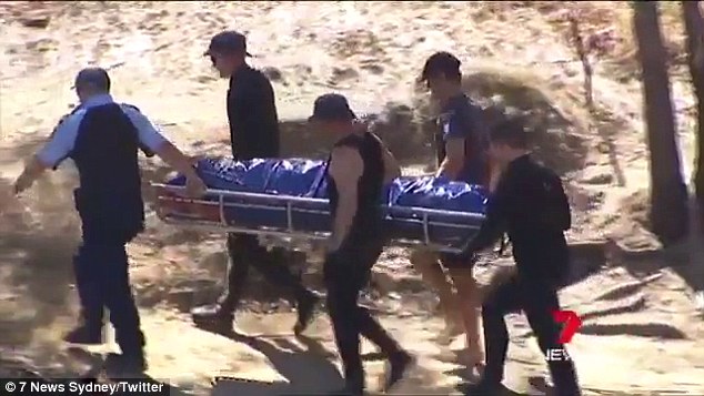 Emergency crews carry the body of a five-year-old boy out of the Murray River on Saturday 