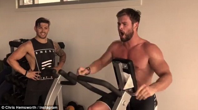 Elsa's a lucky lady! Chris Hemsworth, 33, shows off his bulging biceps and six-pack abs during intense workout with personal trainer Luke Zocchi (left), shared to Instagram on Saturday