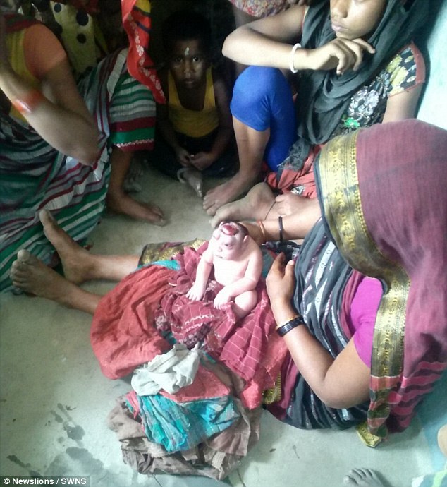 Shocked: The mother-of-four, from Kathihar in the North Indian state of Bihar, initially demanded midwives remove him from sight - but later chose to nurse him 