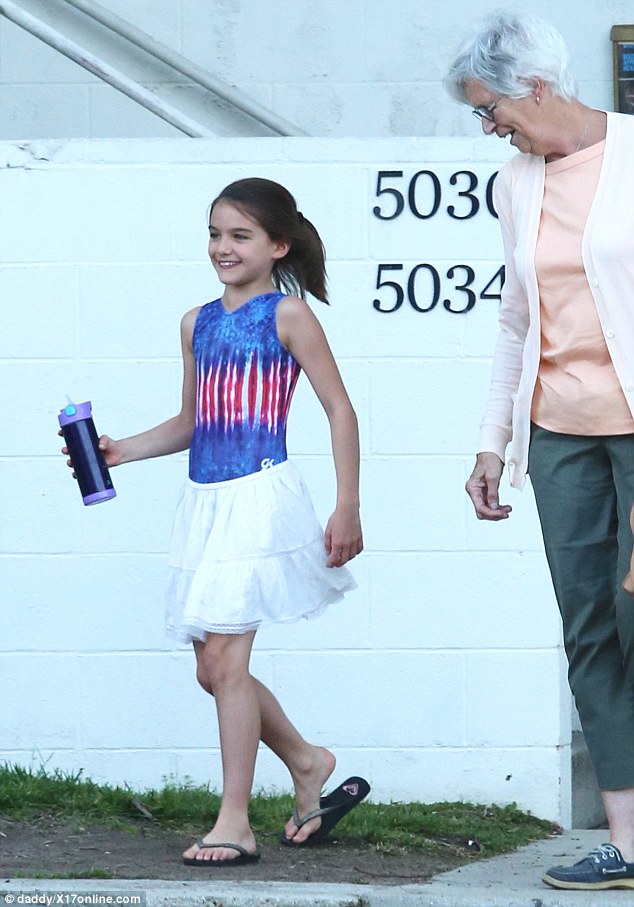 Happy and you know it: Suri Cruise looked to be in good spirits on Thursday as she left a gymnastics class in Los Angeles with her grandmother Kathleen (right); the day before InTouch Weekly reported the child has not seen her father Tom Cruise in 1,000 days