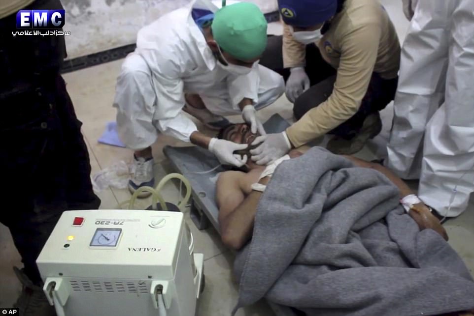 Idlib is regularly targeted in strikes by the regime, as well as Russian warplanes, and has also been hit by the US-led coalition fighting the Islamic State group, usually targeting jihadists. pictured above, a victim of a suspected chemical attack as he receives treatment at a makeshift hospital