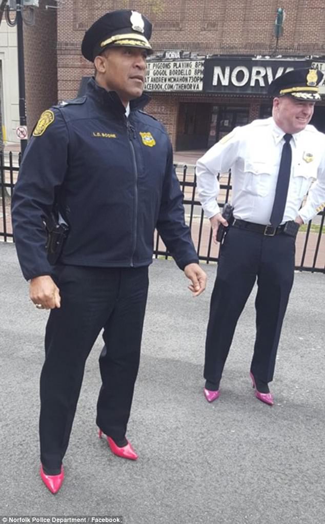 Chief L. Boone, left, and Deputy Chief J. Clark Walk a Mile in Her Shoes in crimson and magenta pumps, to bring awareness to rape, sexual assault and gender violence, in downtown Norfolk