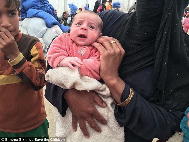 Newborn Lubna, who is less than a month old, was carried to safety after being born in the west of the city