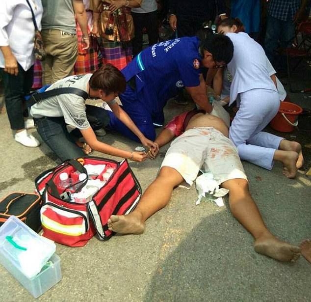 Paramedics desperately try to resuscitate Theprit Palee after he stabbed himself in the heart