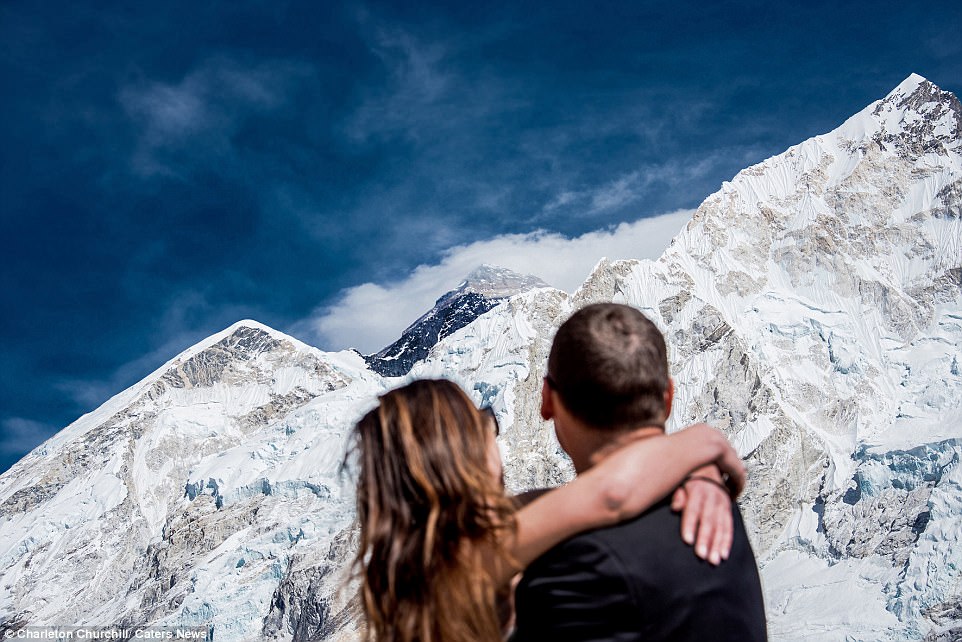 View from the top: Arms wrapped around each other, the newlyweds gaze towards the world's highest peak