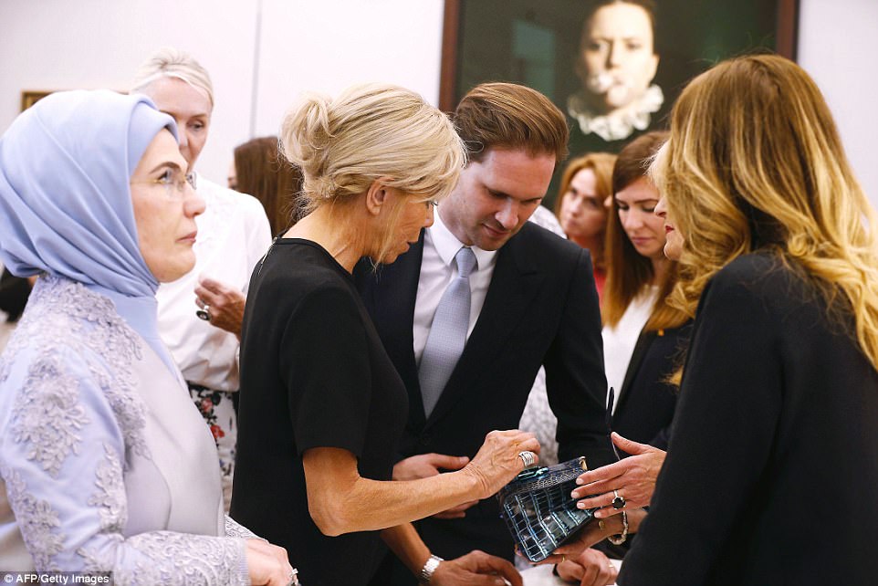 Destenay appeared to be looking at something on French First Lady Brigitte Macron's phone