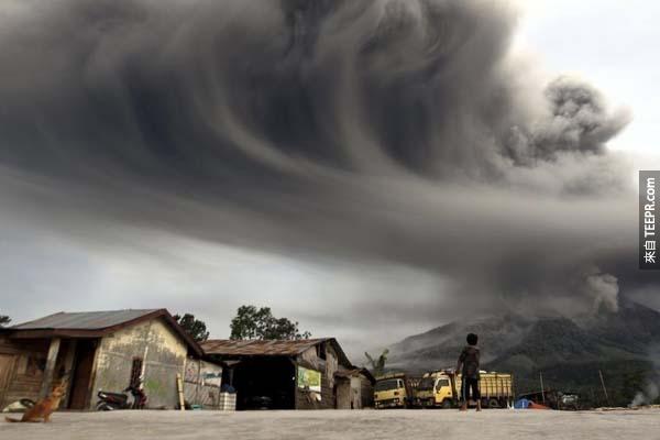 An Indonesian child watches with awe as ash spewed from the top of Mt. Sinabung.