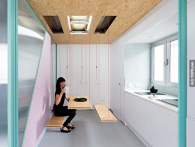 A hanging kitchen table and seats.