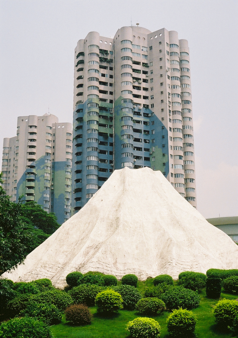 The skyline of Shenzhen is easily seen behind a replica of Japan's Mount Fuji.