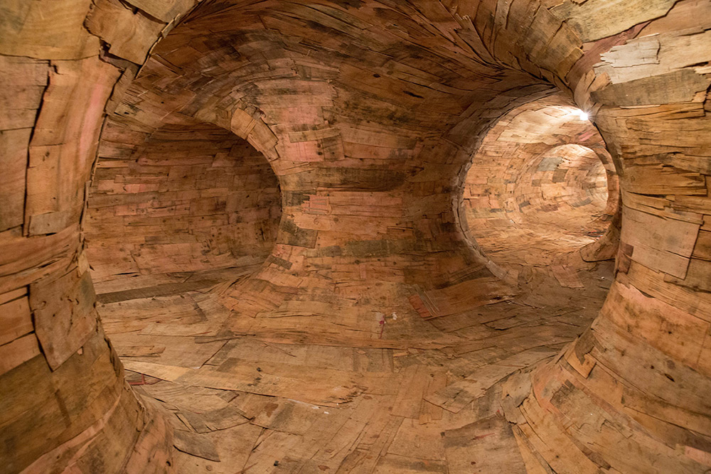 Artist Henrique Oliveira Constructs a Cavernous Network of Repurposed Wood Tunnels at MAC USP wood installation architecture 