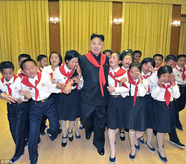 Obese Kim is believed to have sprained then fractured his ankles during a gruelling tour of military bases and factories in shoes with Cuban heels to give him a little more height. He is pictured walking surrounded by weeping members of the Korean Children's Union